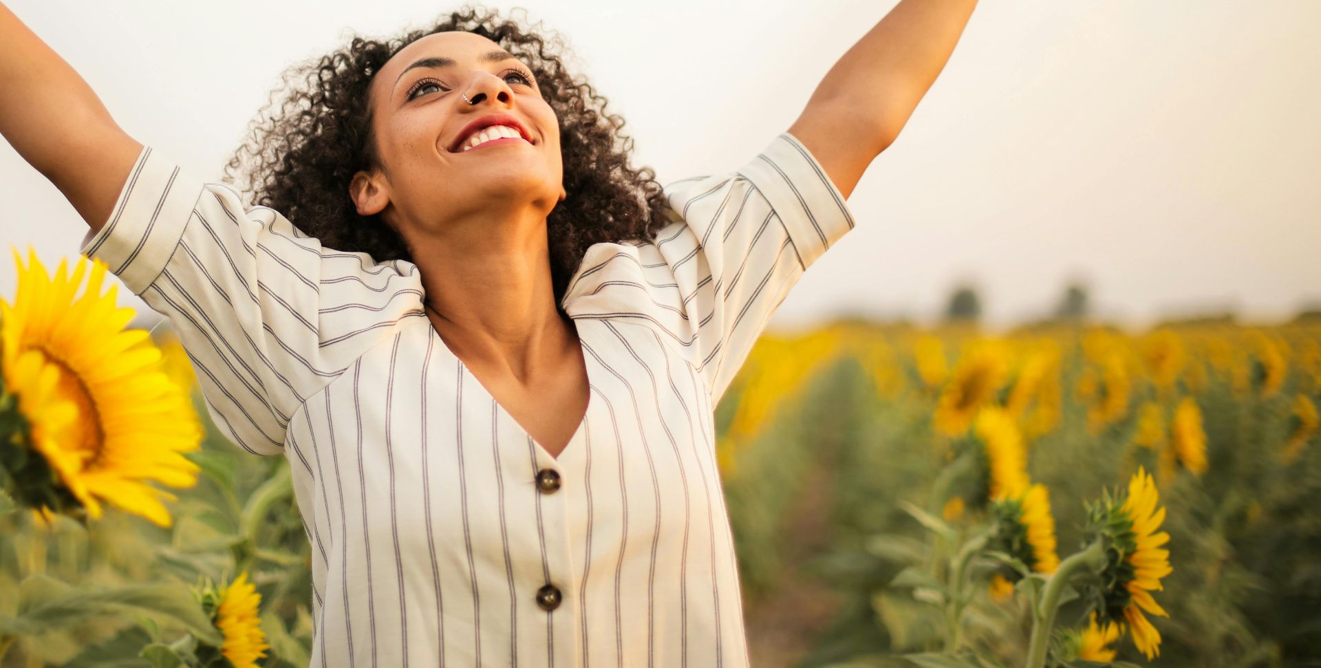 Photo Of Woman Standing On Sunflower Field